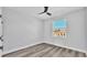 Bedroom showcasing a window, ceiling fan, and modern wood-look flooring at 6421 Highlands Oak Trl, Lakeland, FL 33813