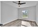 Bright bedroom with a ceiling fan, ample natural light, and modern vinyl plank flooring at 6421 Highlands Oak Trl, Lakeland, FL 33813