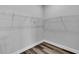 Walk-in closet with wire shelving and light gray wood-look flooring at 6421 Highlands Oak Trl, Lakeland, FL 33813