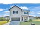 Charming two-story home with a well-manicured lawn, stylish gray garage door and lovely front porch at 6421 Highlands Oak Trl, Lakeland, FL 33813
