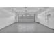 Spacious two-car garage with a clean, epoxy-coated floor and an automatic door system at 6421 Highlands Oak Trl, Lakeland, FL 33813