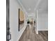 Spacious hallway with wood flooring, neutral walls, and an arched entryway leading to the living areas at 6421 Highlands Oak Trl, Lakeland, FL 33813