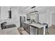 Modern kitchen with stainless steel appliances, a spacious island with bar seating, and stylish pendant lighting at 6421 Highlands Oak Trl, Lakeland, FL 33813