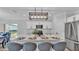 Modern kitchen with an island featuring bar seating, pendant lighting, and stainless steel appliances at 6421 Highlands Oak Trl, Lakeland, FL 33813