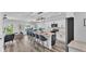 Stylish open concept kitchen with a large island, pendant lighting, bar seating and stainless steel appliances at 6421 Highlands Oak Trl, Lakeland, FL 33813