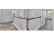 Upstairs landing featuring wood-look floors, white trim, leading to secondary rooms at 6421 Highlands Oak Trl, Lakeland, FL 33813