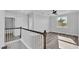 Bright upstairs landing with wood-look floors, crown molding, with open view to other rooms and window at 6421 Highlands Oak Trl, Lakeland, FL 33813