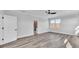 Bright main bedroom with wood-look floors, large windows, and en-suite bathroom access at 6421 Highlands Oak Trl, Lakeland, FL 33813