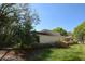 Backyard featuring mature landscaping and a neutral colored two-story home at 6620 Lake Clark Dr, Lakeland, FL 33813