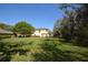 A spacious backyard, with a well-maintained lawn, surrounding a charming house at 6620 Lake Clark Dr, Lakeland, FL 33813