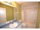 Bathroom featuring patterned wallpaper, vanity with mirror, and a shower-tub combo with white tiling at 6620 Lake Clark Dr, Lakeland, FL 33813