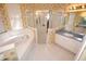 Bathroom featuring a soaking tub, walk-in shower, and single sink vanity at 6620 Lake Clark Dr, Lakeland, FL 33813