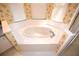 Bathroom features a white tiled corner whirlpool tub with chrome fixtures at 6620 Lake Clark Dr, Lakeland, FL 33813