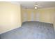 Spacious bedroom with neutral walls, gray carpet, and multiple closet doors at 6620 Lake Clark Dr, Lakeland, FL 33813