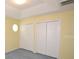 Bedroom with carpeted floor and double closets for ample storage at 6620 Lake Clark Dr, Lakeland, FL 33813