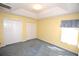 Bedroom featuring carpet, yellow walls, two closets, and a window with patterned valance allowing natural light at 6620 Lake Clark Dr, Lakeland, FL 33813