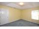 Bedroom with neutral walls, carpeted floor, and a window allowing natural light at 6620 Lake Clark Dr, Lakeland, FL 33813