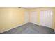 Bedroom with carpet, yellow walls, two closets, white trim and a door to another room at 6620 Lake Clark Dr, Lakeland, FL 33813