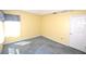 Bedroom featuring carpet, yellow walls, white trim and a window with patterned valance allowing natural light at 6620 Lake Clark Dr, Lakeland, FL 33813