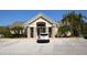 Well-maintained clubhouse exterior with stone accents, manicured landscaping, and ample parking at 6620 Lake Clark Dr, Lakeland, FL 33813