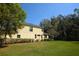 Charming two-story home featuring a lush lawn and mature landscaping at 6620 Lake Clark Dr, Lakeland, FL 33813