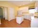 Well-lit kitchen features white cabinets, central island, and hardwood floors at 6620 Lake Clark Dr, Lakeland, FL 33813