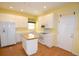 Bright kitchen featuring white cabinets, an island, and wood floors at 6620 Lake Clark Dr, Lakeland, FL 33813