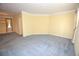 Spacious room with gray carpet, yellow walls, and an ornate chandelier at 6620 Lake Clark Dr, Lakeland, FL 33813