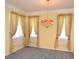 Living room with neutral walls, gray carpet, and an ornate chandelier at 6620 Lake Clark Dr, Lakeland, FL 33813
