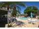 Beautiful pool area with lounge chairs, umbrellas, and tables ideal for outdoor gatherings at 6620 Lake Clark Dr, Lakeland, FL 33813