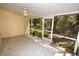 Screened porch with ceiling fan, tile floor, and view of lush landscaping at 6620 Lake Clark Dr, Lakeland, FL 33813