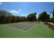 Well-maintained tennis court surrounded by lush landscaping, inviting residents to engage in friendly competition at 6620 Lake Clark Dr, Lakeland, FL 33813