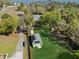 Scenic aerial view of a property with a detached garage with solar panels and a long driveway near the water at 6810 Crystal Beach Rd, Winter Haven, FL 33880