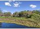 Aerial view showcases the home's setting amidst lush landscaping and water views at 6810 Crystal Beach Rd, Winter Haven, FL 33880