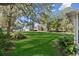 Expansive backyard with lush green lawn and mature trees providing ample shade and a serene outdoor setting at 6810 Crystal Beach Rd, Winter Haven, FL 33880