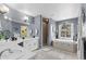 Bright bathroom featuring a soaking tub beneath a window and a separate glass shower at 6810 Crystal Beach Rd, Winter Haven, FL 33880