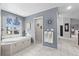 Bright bathroom featuring a soaking tub beneath a window with natural light at 6810 Crystal Beach Rd, Winter Haven, FL 33880