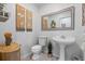 Charming bathroom featuring neutral walls, decorative mirror and lights, and new fixtures at 6810 Crystal Beach Rd, Winter Haven, FL 33880