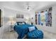 Inviting bedroom with plush blue bedding, reading nook, and built-in bookshelves at 6810 Crystal Beach Rd, Winter Haven, FL 33880