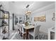 Bright dining room features a modern chandelier, large windows and seating for six at 6810 Crystal Beach Rd, Winter Haven, FL 33880