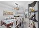 Contemporary dining room with a glass-top table, modern art, and open access to the living spaces at 6810 Crystal Beach Rd, Winter Haven, FL 33880