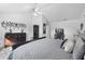 Spacious main bedroom boasts a ceiling fan, dresser, armoire and sitting area at 6810 Crystal Beach Rd, Winter Haven, FL 33880