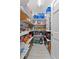 Walk-in pantry with custom shelving providing ample storage space for kitchen essentials at 6810 Crystal Beach Rd, Winter Haven, FL 33880
