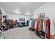 Bright walk-in closet with neutral walls and tile flooring, clothing racks, and hat rack at 6810 Crystal Beach Rd, Winter Haven, FL 33880