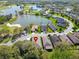 Aerial view of a house next to a lake, golf course, and other residential properties at 6907 Eagle Ridge Blvd, Lakeland, FL 33813