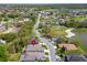 Bird's eye view of the house located on a street in a neighborhood near a lake and golf course at 6907 Eagle Ridge Blvd, Lakeland, FL 33813