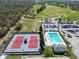 Aerial view of community pool, tennis courts, parking, and golf course at 6907 Eagle Ridge Blvd, Lakeland, FL 33813