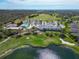 Aerial view of clubhouse overlooking the golf course and a lake at 6907 Eagle Ridge Blvd, Lakeland, FL 33813