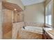 Bathroom features tiled shower, tub, window with shutters, and vanity at 6907 Eagle Ridge Blvd, Lakeland, FL 33813