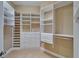 Walk-in closet features custom shelves, cabinets, drawers, and racks at 6907 Eagle Ridge Blvd, Lakeland, FL 33813